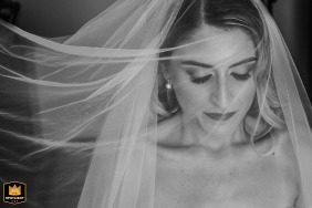 In Partinico (PA), a black and white portrait captures the bride with her veil sweeping gracefully across the left side of the tightly cropped frame, adding an elegant touch to the image.